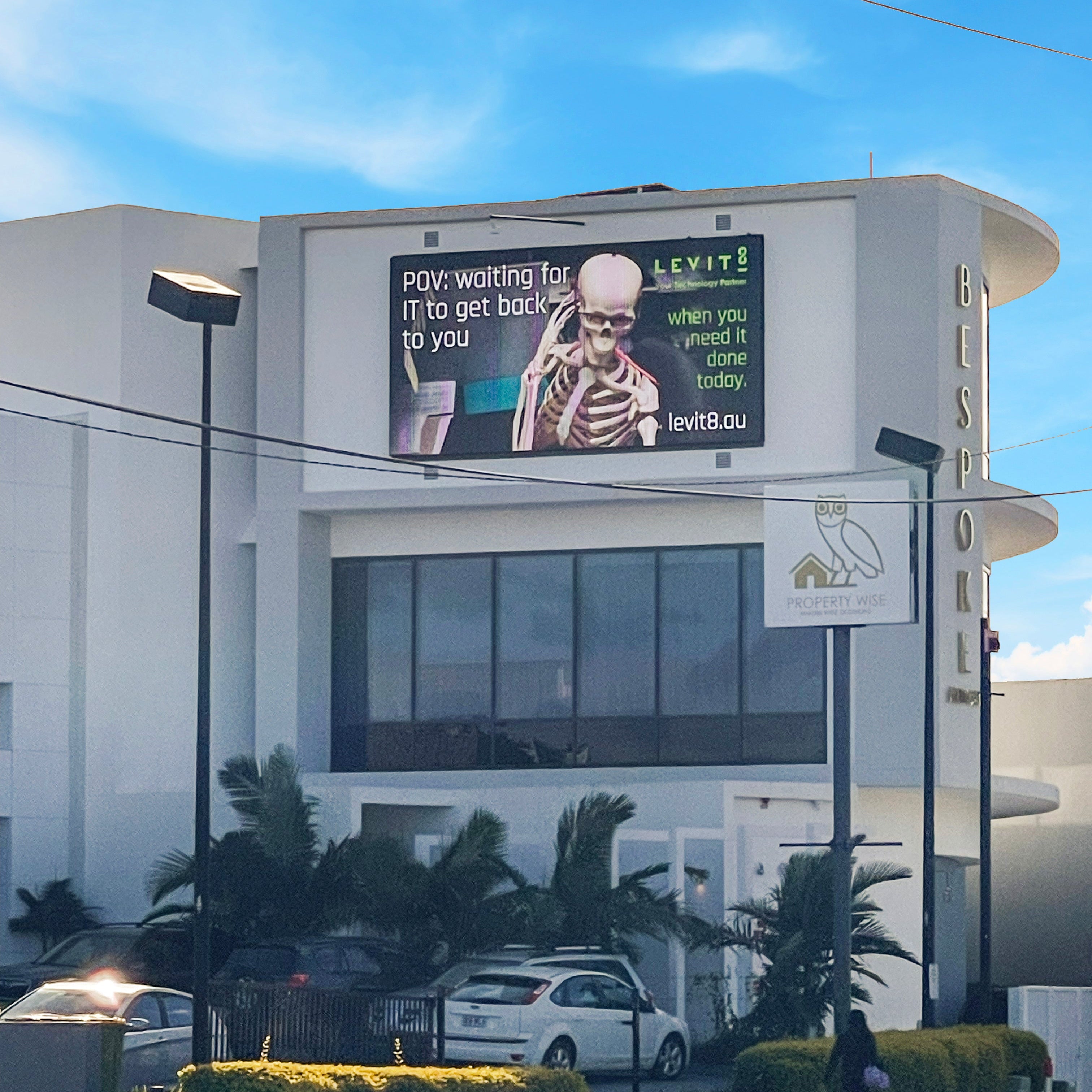 Building exterior with a large digital billboard displaying an advertisement.