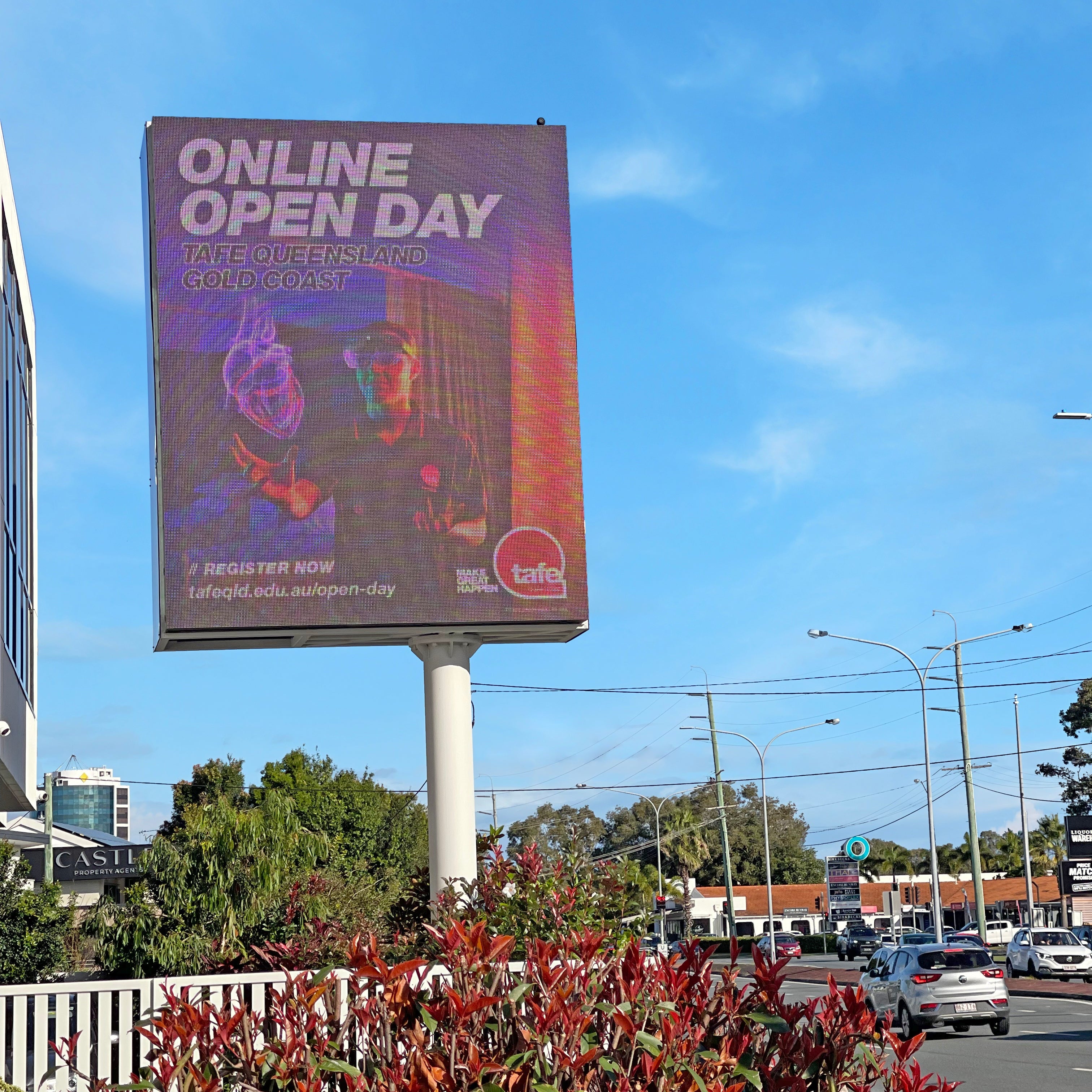 Billboard advertising an 'Online Open Day' against a blue sky with some clouds.